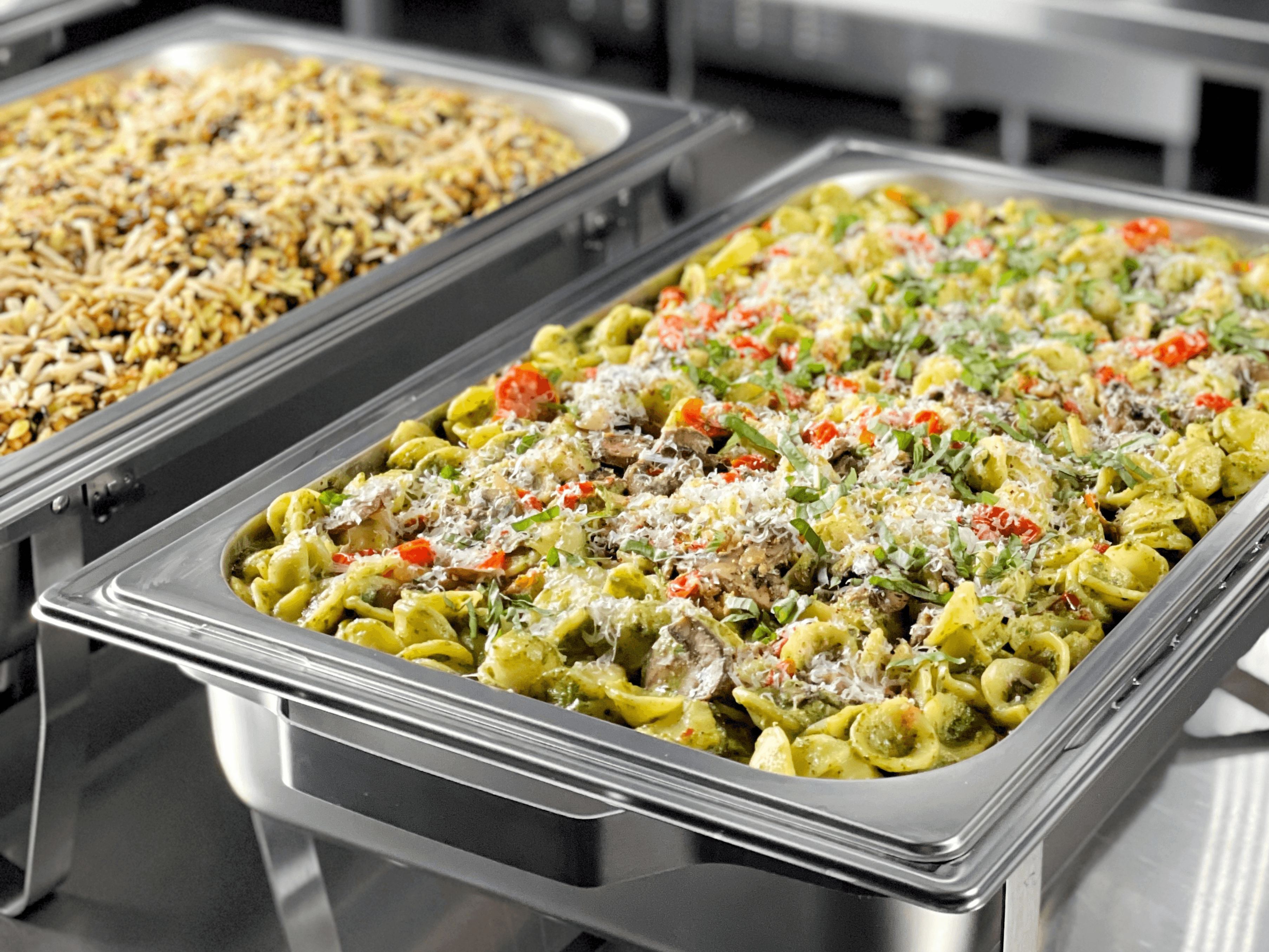 Catered pasta and rice in chafing dishes.