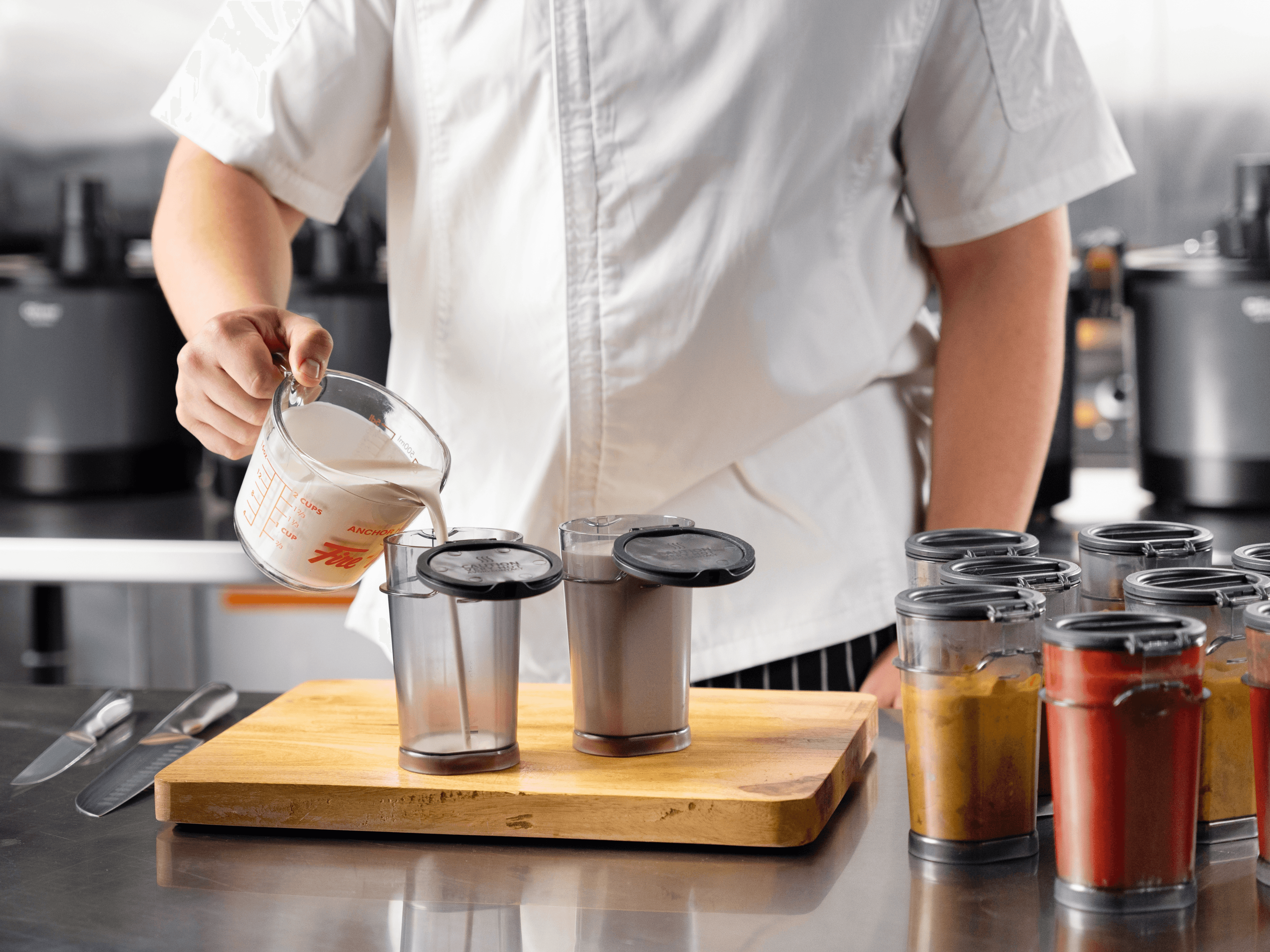 Chef in a commercial kitchen preparing ingredients for a meal.